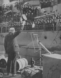 Churchill responds to the cheers from the crew of HMS Prince of Wales
