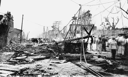 Earthquake damage and a burnt car, King Street, Kingston, Jamaica