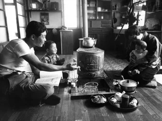 Family relaxing in their living-room, Hokkaido region, Japan