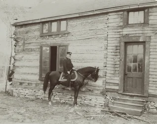General Frederick Dent Grant on horseback in front of the cabin (Hardscrabble) built by his father, Ulysses S. Grant