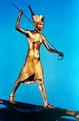 Gold figure of King Tutankhamun standing on a reed boat and spearing fish, 14th century BC