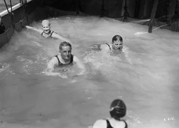 Passengers in the swimming pool on board a cruise ship