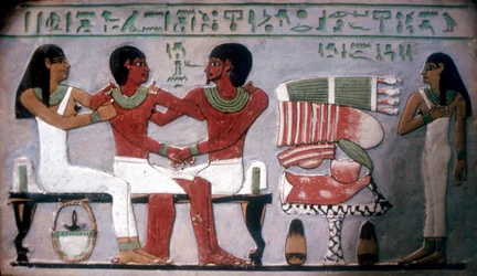 Relief of Imn-Hat seated with his wife & son in front of an offering