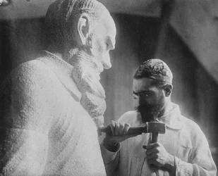 Russian sculptor Sergey Merkurov 1881-1952 working on his statue of Leo Tolstoy