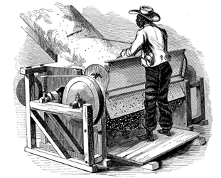 Saw gin for cleaning cotton being operated by barefoot Black labourer, southern USA, 1865