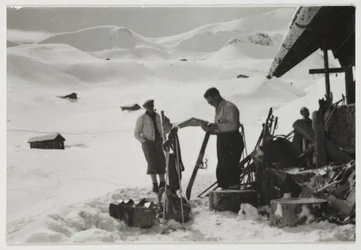 Skiers outside a chalet, c 1930