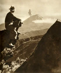 The Rotorua district in the North Island of New Zealand - The climber is resting on a rocky prominence