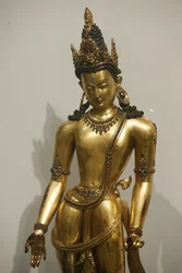 The Bodhisattva Avalokiteshvara (Padmapani, bearer of the lotus). 1300-1400. Malla dynasty. Nepal. Gilded copper with precious and semi-precious stones. United Kingdom