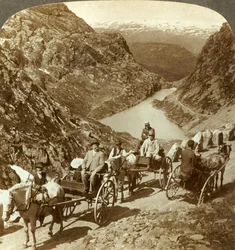 Travellers on mountain road through wild ravine of Seljestad, Norway