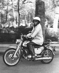 United States: c.1961 A woman riding her Honda 160 motorcycle