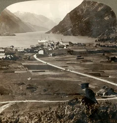 Village roofs and sunny fields of Odde, N. up the narrow mountain-walled Sorfjord, Norway