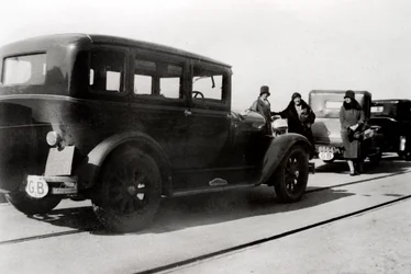 Women and parked cars