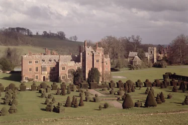 Exterior Showing Topiary Garden and Church Beyond, Compton Wynyates, Warwickshire