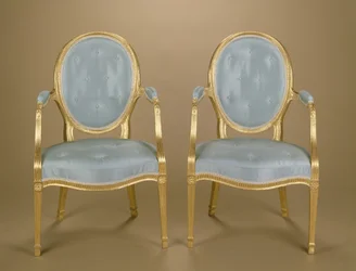 Pair of Adam oval-backed gilt carver chairs, blue upholstered, c.1780