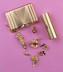 Selection of Art Deco jewellery: two cigarette cases; ruby cluster flower brooch and earrings; cocktail watch (gold)