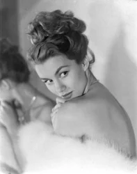 A young woman peers coyly over her shoulder, circa 1948: Winking