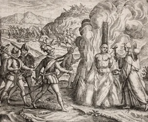 Description of the crimes inflicted on the Indians by the Spanish colonists - Conquistadors burning at the stake an Indian who refused to convert to the Catholic faith. Religious of the Franciscan Order (engraving)