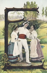 E: A Man Dressed in White and Red Standing Between Two Women Wearing Skirts, Bodices, and Aprons. Countryside Setting - Alphabet Characters Ref Th. E., L. Theochrom - Series 994. Theodor Eisman, publisher, Leipzig
