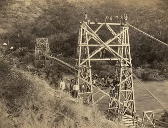 Fresno, California: 1890. This photograph by C.C. Curtis shows the Smith and Moore bridge over the Kings River, which is part of a flume built by Hiram T. Smith and Austin D. Moore to transport lumber from the Sierras for their company, the Kings River