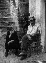 Man and Woman in Front of Their House