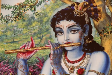 Painting depicting Hindu god Krishna playing a flute outdoors, India