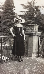 Portrait of a woman leaning against the balustrade of a terrace