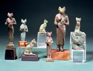Several statuettes of the cat-goddess Bast and cat figurines representing the same goddess, Egyptian, Late Period, c.664-300 BC