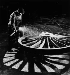 Sparks fly as man grinds locomotive wheel at Darlaston foundry