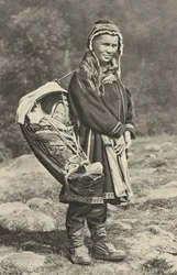 Sweden. Lapp woman carrying her baby in a cradle of reindeer skin. 1920