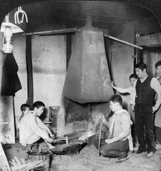 A Japanese blacksmith at his forge, Yokohama, Japan, 1904
