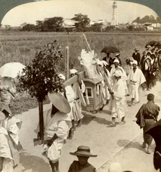 Funeral procession of a rich Buddhist, on the road to Sakai, looking towards Osaka, Japan