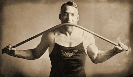 Californian Strongman Mr. P. A. Linebarger bends an iron bar with his teeth, San Francisco c.1922