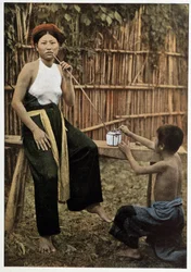 Asian woman smoking opium, circa 1898