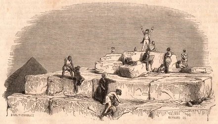 View from the top of the Great Pyramid of Khufu: a group of Europeans arriving on the summit helped by Egyptians