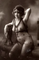 A young woman sitting down, wearing a transparent dress