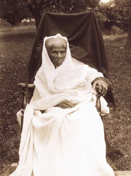 Harriet Tubman, full-length portrait, seated in chair, facing front, probably at her home in Auburn, New York