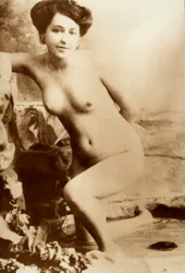 Nude portrait of a young woman getting out of a tub