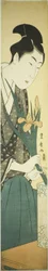 Young man arranging irises in a vase