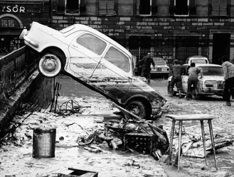 An automobile thrown over a balustrade in the Via dei Renai during the flood of Florence, November 1966
