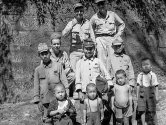 American soldiers with Japanese family pose together after Japanese surrender