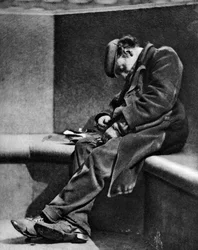 A man sleeping on Blackfriars Bridge, London, 1926-1927
