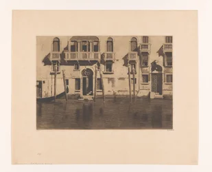 View of facades and mooring posts along the Canale Grande in Venice