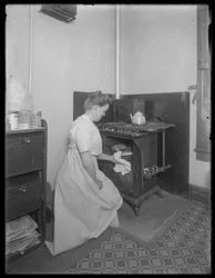 Ethel Gray Magaw Hassler taking bread from the oven