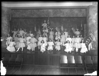 Group portrait of little girls during a performance, probably the Roman Catholic Orphan Asylum, Kingsbridge, Bronx, c.1911