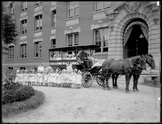 Small Girls Pose in and in Front of a Horse-Drawn Wagon, in Front of an Unidentified Building, Probably the Roman Catholic Orphan Asylum, Kingsbridge, Bronx