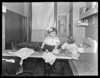 Unidentified Little Girl Demonstrating the Use of an Electric Iron