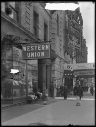 Western Union office sign at W. 125th Street and St. Nicholas Avenue, New York City, April 28, 1916