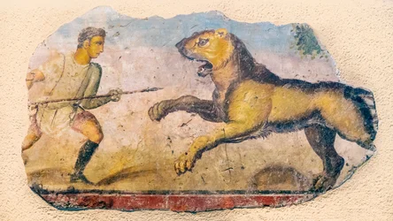 A Roman hunter confronting a charging lion.