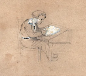 Schoolboy at work on his desk